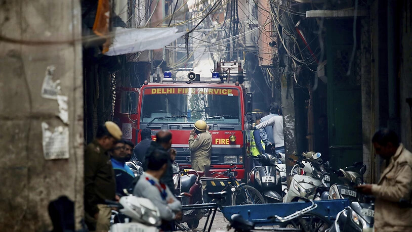 Für ein Feuerwehrauto, das in der Nähe des Brandortes steht, gab es in den engen Gassen fast kein Durchkommen mehr. Beim Grossbrand in einer indischen Fabrik starben über 40 Menschen. (AP Photo/Manish Swarup)