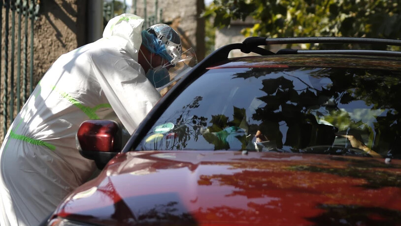 Prag: Ein junger Autofahrer wird an einer Drive-in-Teststation auf Covid-19-Symptome geprüft. In Tschechien breitet sich das Coronavirus weiter rasant aus. Foto: Petr David Josek/AP/dpa