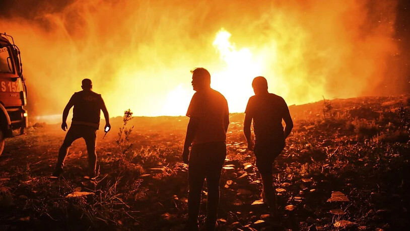 dpatopbilder - Feuerwehrleute und Dorfbewohner versuchen ein Feuer in der Provinz Antalya unter Kontrolle zu bringen. Foto: Uncredited/AP/dpa