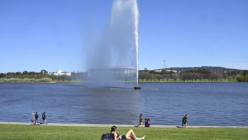 A resident enjoys the sunshine at the shore of Lake Burley Griffin in Canberra, Friday, September 17, 2021. ACTs third lockdown extension five weeks into its outbreak follows concern about the continued number of cases infectious in the community. (AAP…