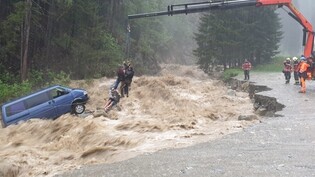 Ein Auto wird während eines Hochwasserereignisses in Splügen GR in den Bach gerissen. (Archivbild)